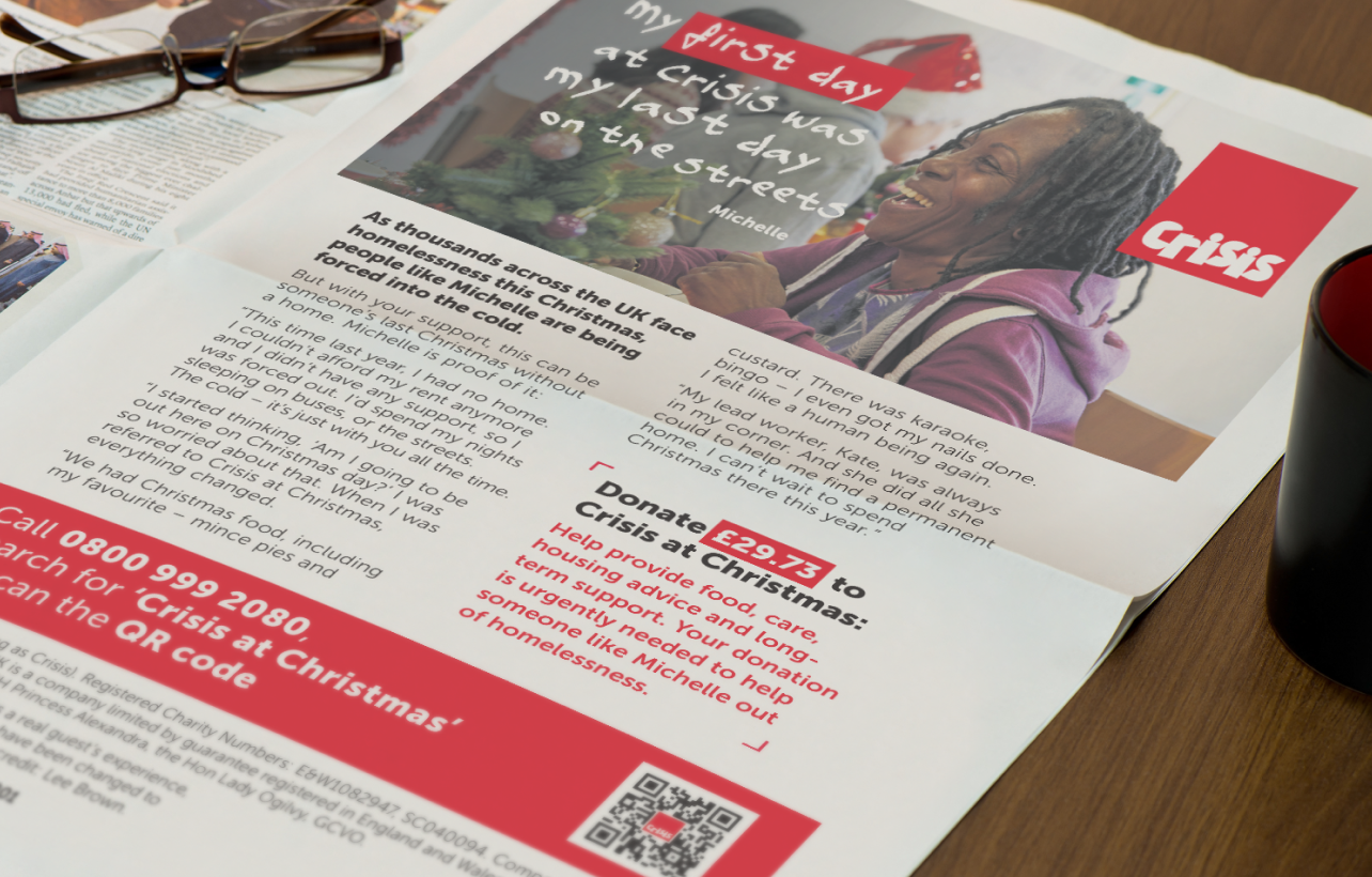 A photograph of a newspaper with text and imagery of the Crisis First Day campaign