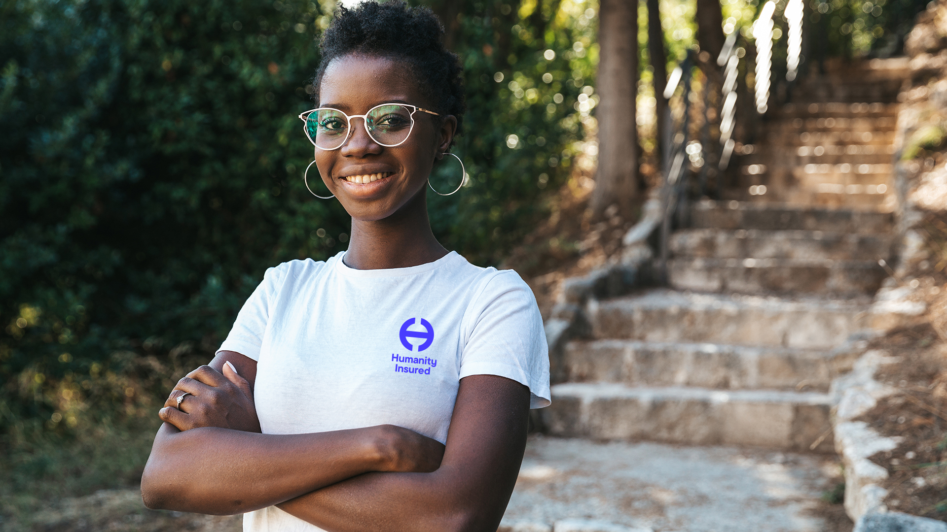 A woman in a Humanity Insured branded t shirt