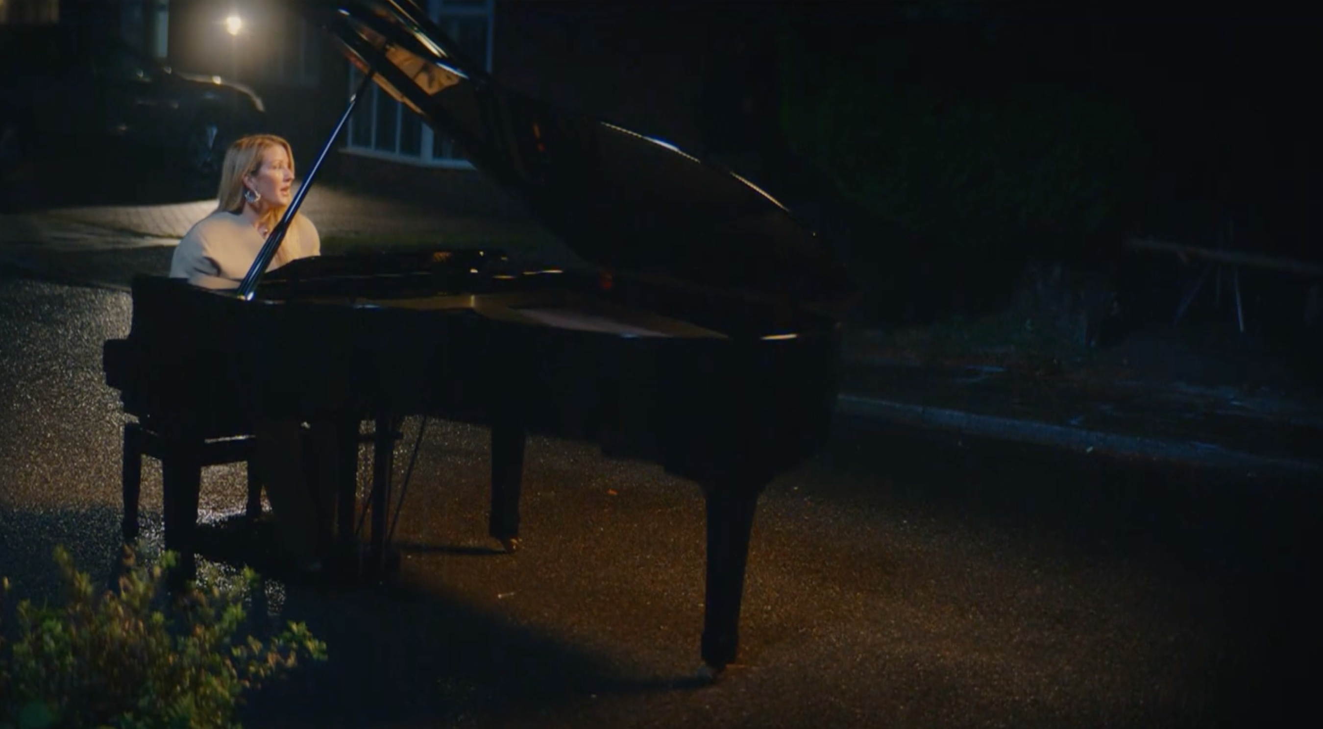 Ellie Goulding playing and singing by a piano
